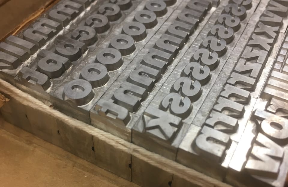 photo represents a set of lead type, bound by cotton twine.